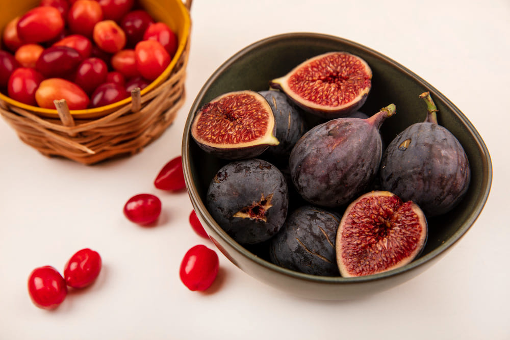Freshly picked ripe figs split open showing the sweet red flesh inside